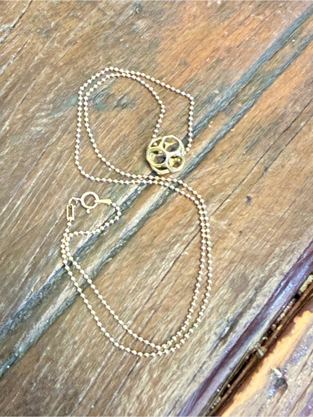 Gold-Tone Ball Chain Necklace with Decorative Floral Medallion